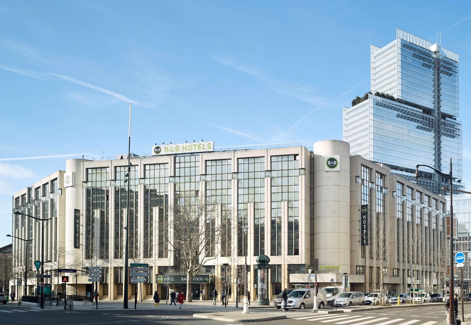 Exterior of B&B HOTEL Paris 17 Batignolles, showing the light-coloured facade, rows of windows and street-level entrances.