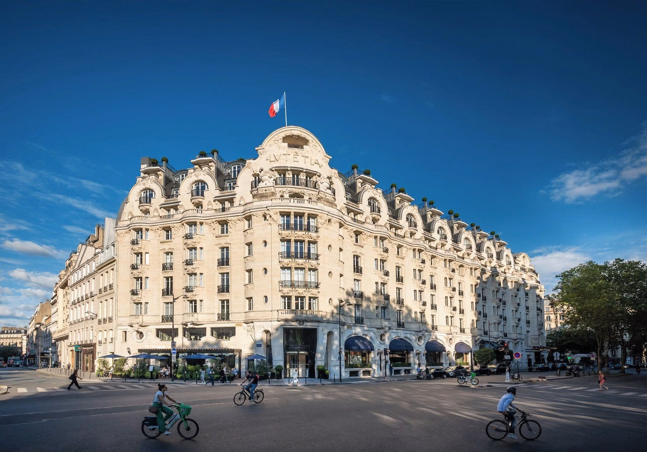 Exterior of Mandarin Oriental Lutetia Paris, showing its stone facade and French flag.
